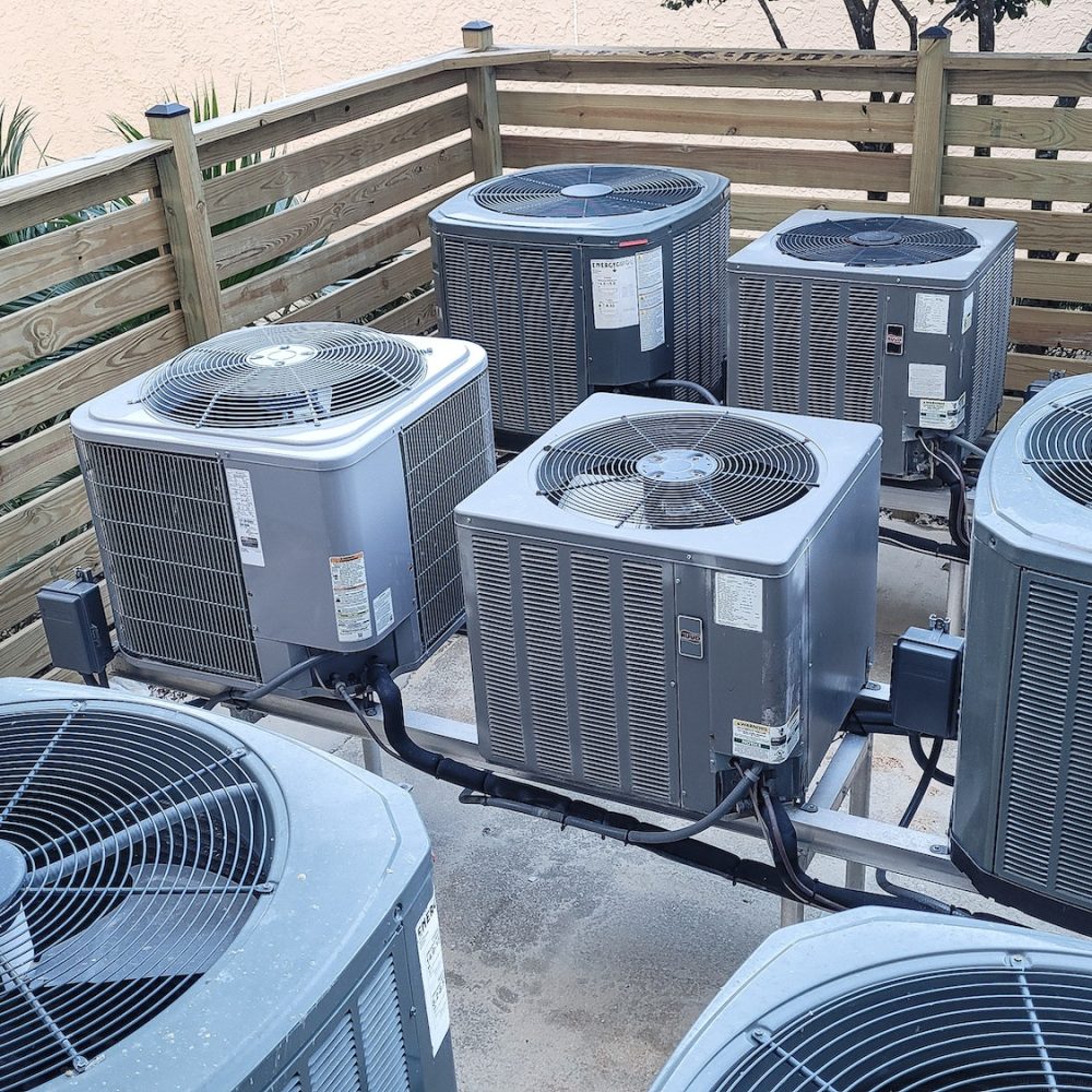 Air conditioners raised platforms at beach serviced by HVAC technicians .