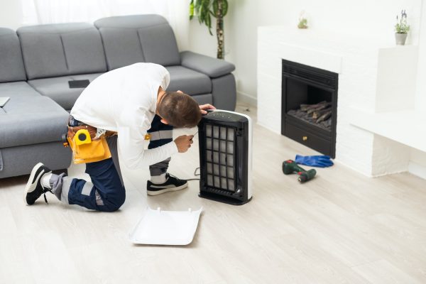 air purifier repairman turning a filter into a new one