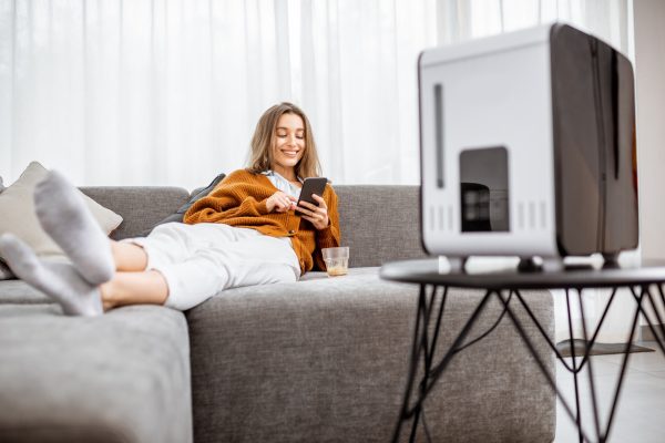 Woman with air humidifier at home